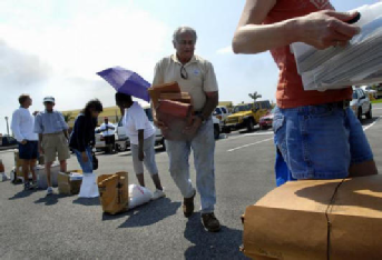 PORT ST. LUCIE - “I’ve never seen this done before. My hat’s off to the city for providing this service,” said Dan Spinogatti, center, of St. Lucie West, who was one of many people who waited in line to have papers with sensitive material shredded Tuesday morning at the Port St. Lucie Civic Center. The event was initiated by the Port St. Lucie Police Department and the shredding services were provided by ShredAssured, of West Palm Beach, who donated their time.